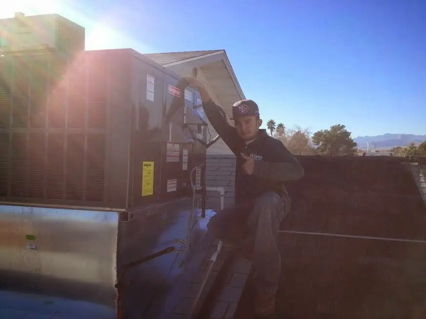HVAC technician performing HVAC Inspection on a rooftop unit in Burbank